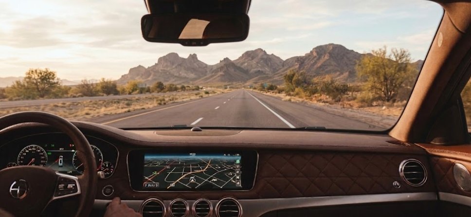 Car interior view through windshield on Arizona desert road